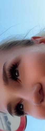 Customer's close-up view of THE CAT EYE lash extensions, showing long dark lashes with a defined lift.