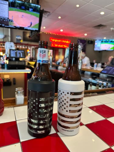 Customer's two Frost Buddy Shipping Protection sleeves on beer bottles, on a red and white checkered bar top.