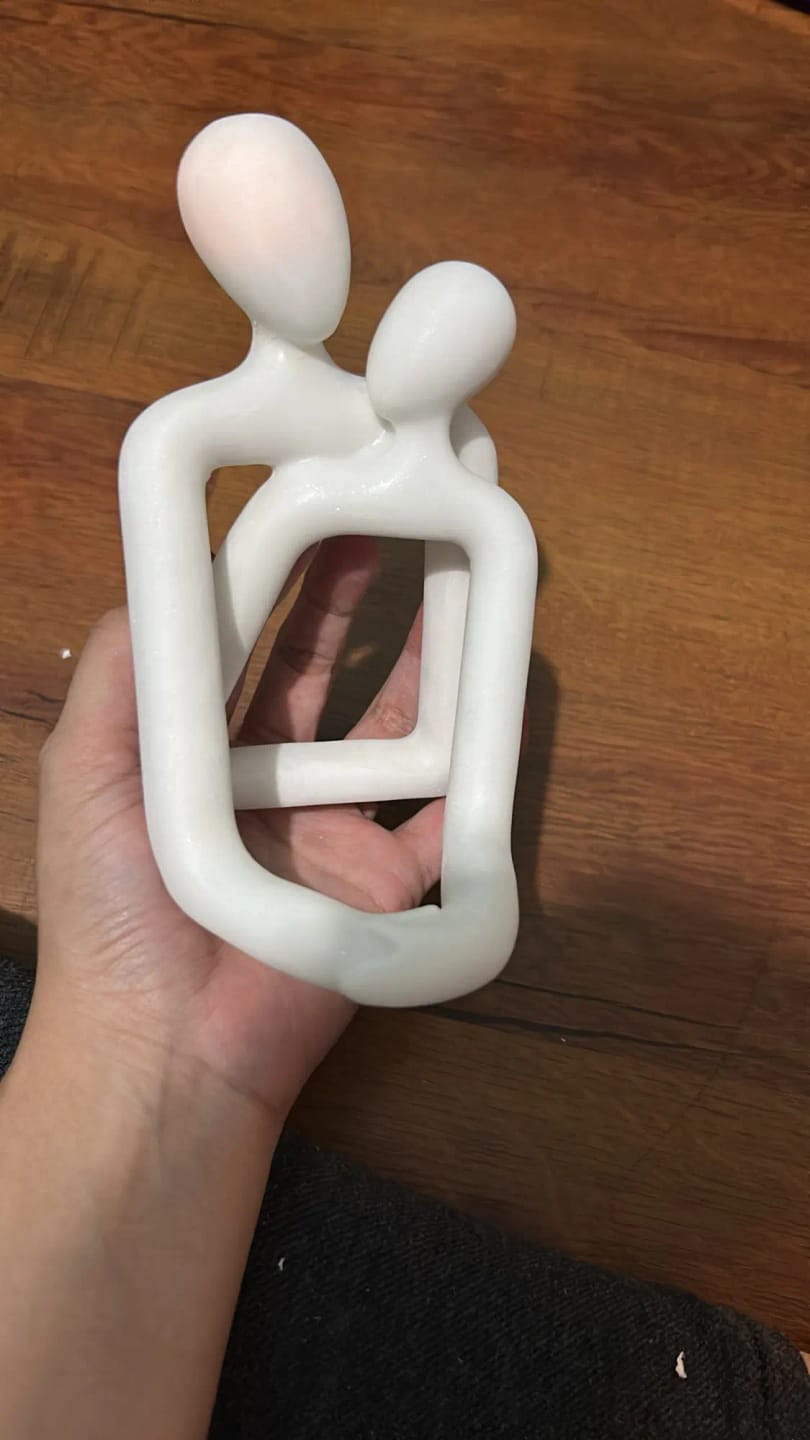 Customer photo review of Couple Embrace Phone Holder Sculpture