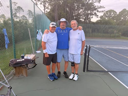 Customer's CUURT Muuv court shoes being worn by three people standing on a tennis court.