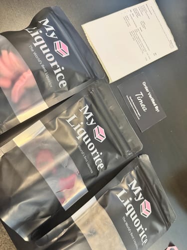 Customer's three bags of Caramel Salmiac Liquorice Truffles with an order verification card on a table