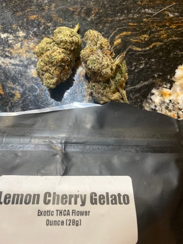 Customer's Lemon Cherry Gelato THCA flower buds next to the product's black resealable packaging.