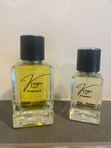 Customer's two Kiage fragrance perfume bottles of different sizes with yellow liquid on a neutral surface.