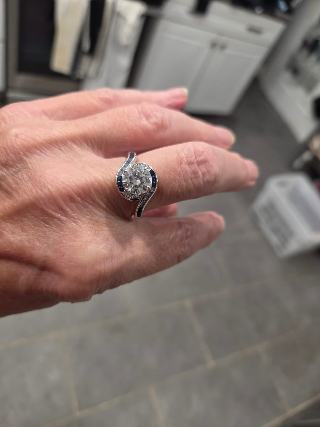 Customer photo review of Bypass Round Moissanite Gradient Ocean Blue Channel Set Engagement Ring