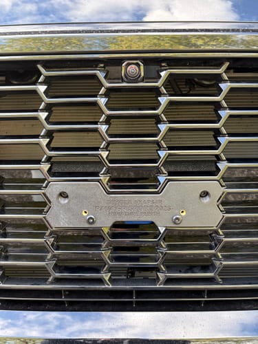 Customer's OEM Plinth Delete Kit for RAV4 GR Sport installed on the front grille, showing a clean metal mount.