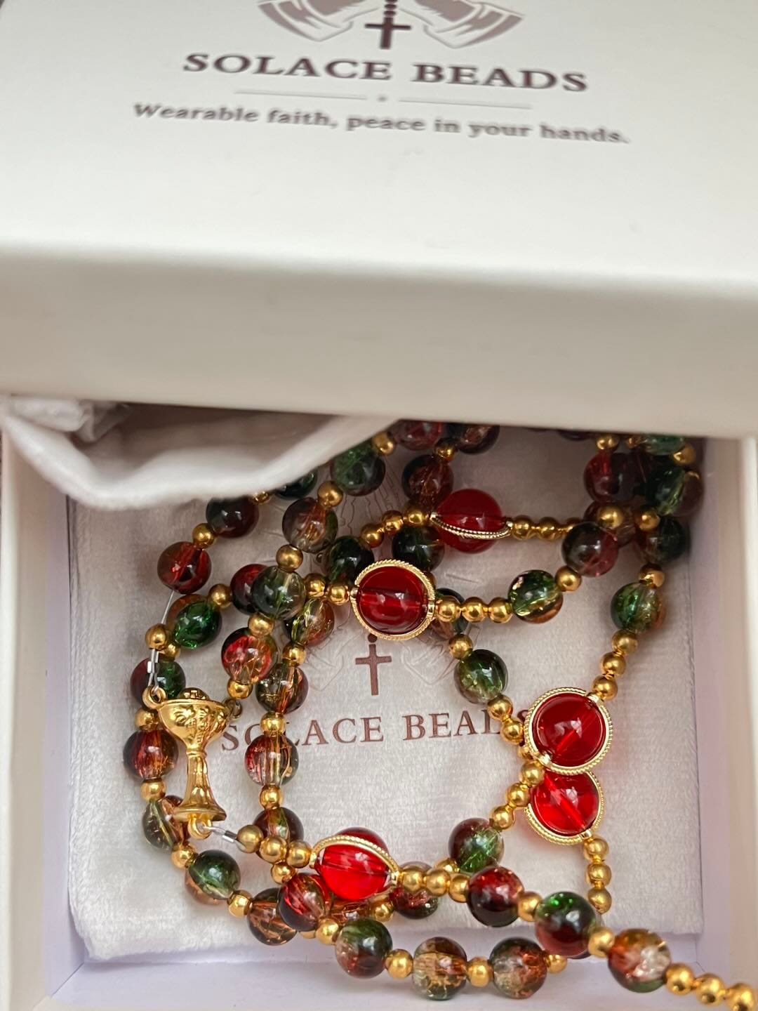 Customer photo review of SolaceBeads Color Glass Rosary, Red Transparent Spacers & Gold Charms: Dazzling Bright Daily Devotion