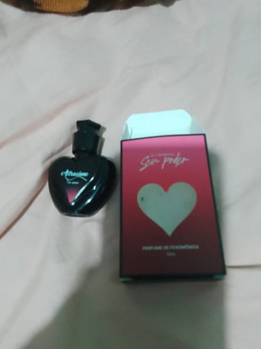 Customer's Attracione Sensual perfume bottle in heart shape and its matching red cardboard box.