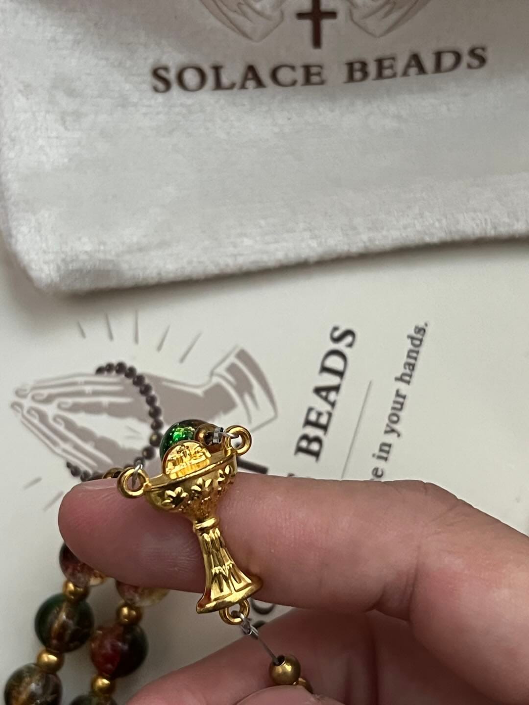 Customer photo review of SolaceBeads Color Glass Rosary, Red Transparent Spacers & Gold Charms: Dazzling Bright Daily Devotion