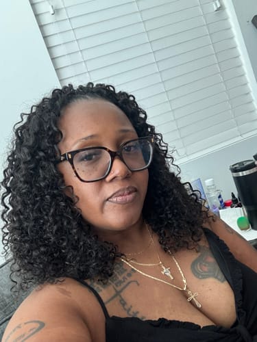 Customer's Spanish Curl Human Crochet Hair installed, showing natural black, voluminous curls.