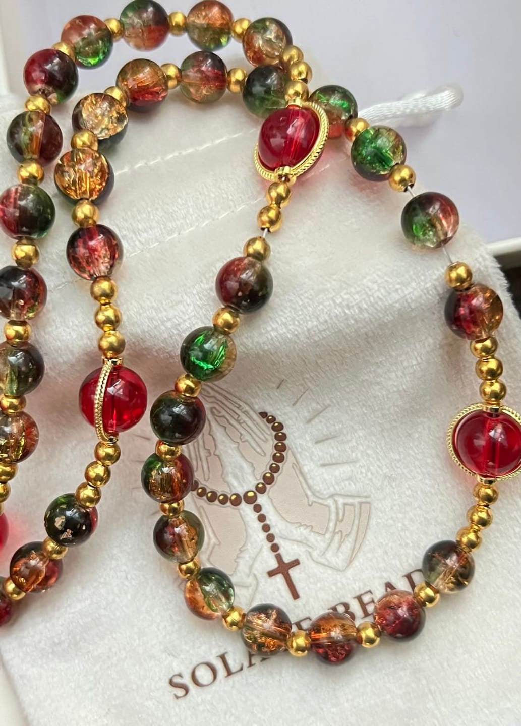 Customer photo review of SolaceBeads Color Glass Rosary, Red Transparent Spacers & Gold Charms: Dazzling Bright Daily Devotion