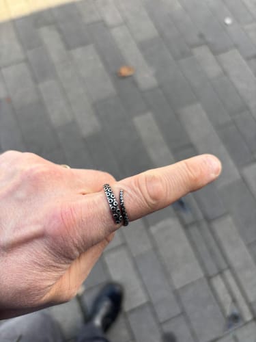 Customer's TENTACLE ring, featuring a silver-tone wrap design with octopus sucker details, worn on a person's finger.