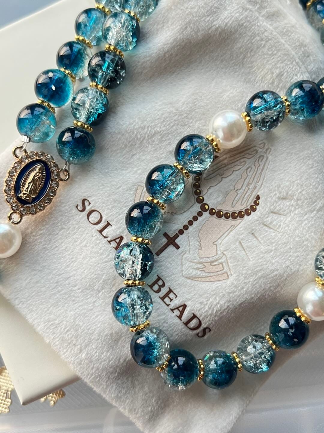 Customer photo review of SolaceBeads Gradient Ocean Crackle Glass Rosary & Pearl Embedded Cross: Rooted in Guadalupe Faith