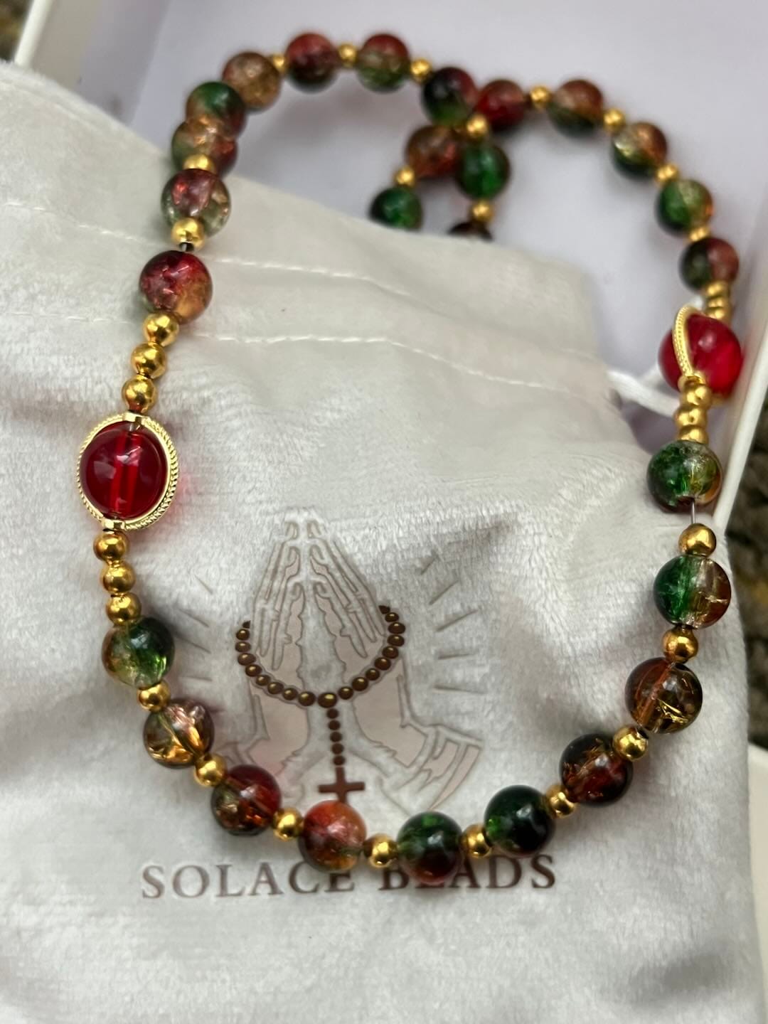 Customer photo review of SolaceBeads Color Glass Rosary, Red Transparent Spacers & Gold Charms: Dazzling Bright Daily Devotion