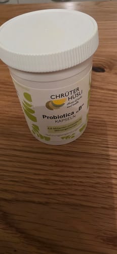Customer's white Probiotica "B" Kapseln tub standing on a wooden surface.