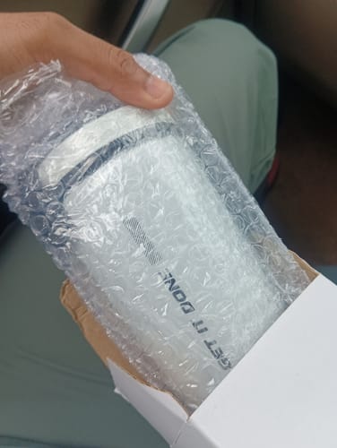 Customer's Wellcore steel shaker wrapped in protective bubble wrap, held in a person's hand.