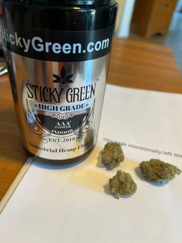 Reviewer's Silver Haze High Grade Flower container with three loose, dense buds on a paper surface.