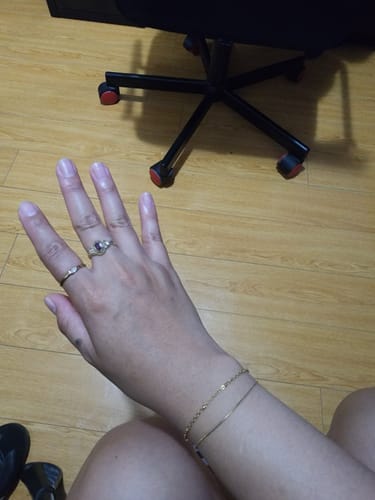 Reviewer's wrist wearing the delicate gold Pia Gold Layered Bracelet, showing its thin, dainty style.