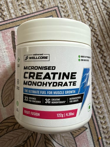 Customer's white Wellcore Creatine Monohydrate tub sitting on a patterned surface.