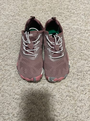 Customer's pair of pink Smart II barefoot shoes, shown from above on a textured carpet.