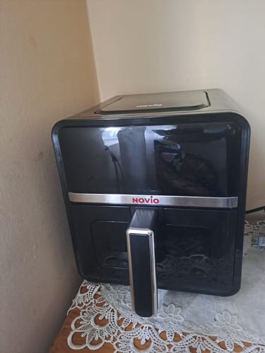 Customer's Novio StonePro air fryer in black, sitting on a table with a decorative lace tablecloth.