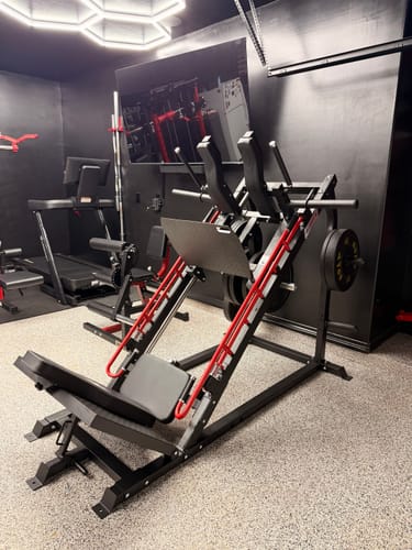 Customer's black and red RitFit Gazelle Pro gym machine set up in a home gym with ambient lighting.