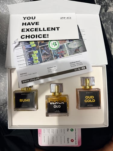 Customer's Royal Oud Collection in an open white gift box, featuring three fragrance bottles: Rumi, Black Oud, and Oud Gold.