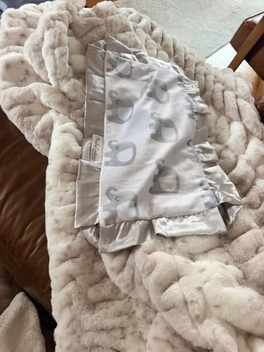 Customer's cream Hugs Cream Fawn Blanket with an elephant-print baby blanket on top.
