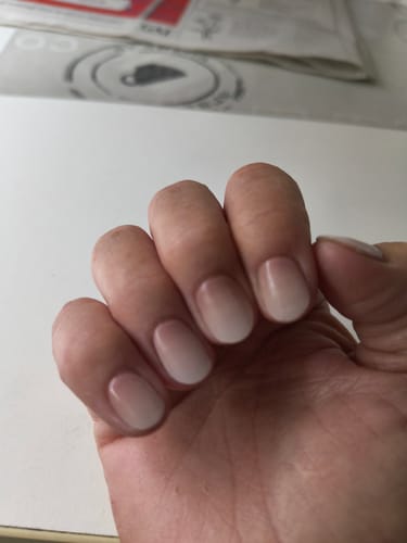 Reviewer's hand showing UV Gel Nail Wraps in Babyboomer Nude with a smooth white-to-nude gradient.