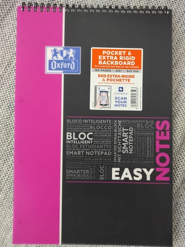 Customer's Oxford Easynotes spiral notebook with a pink and black cover, placed on a textured surface.
