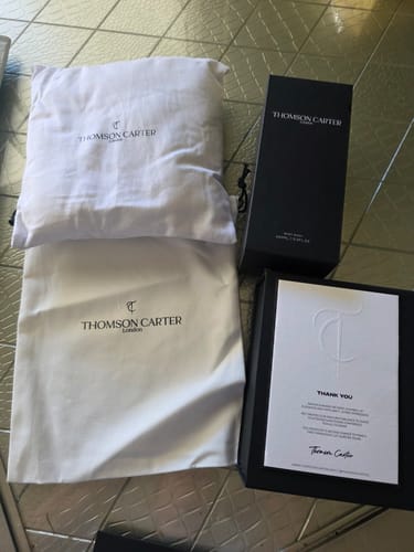 Customer's Smoke & Mirrors packaging including a white fabric bag, a white pillow, and a black box with thank you note.