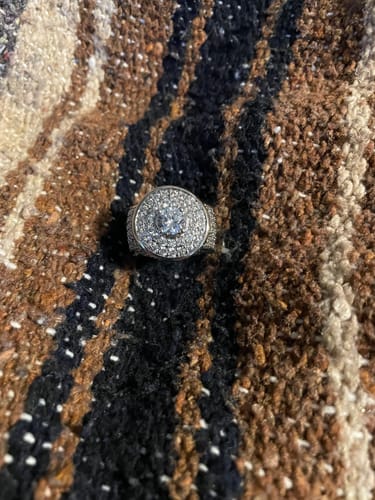Customer's surprise item silver ring with central stone on textured brown fabric