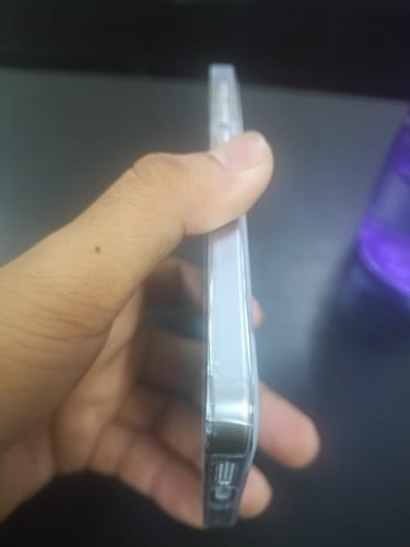 Customer's hand holding a clear, flimsy phone case showing a visible crack along the edge.
