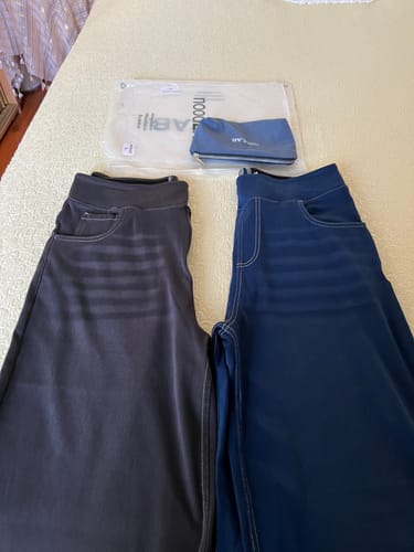 Customer's Noodlab Flex Comfort jeans in anthracite and blue, shown with packaging and a small bag.