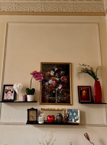 Customer's Flora Music art print hanging centrally on a wall above small shelves with decorative items.