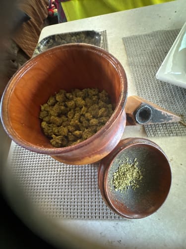 Customer's Candy Runtz minis in a wooden bowl with a small amount of ground flower in a matching wooden grinder.