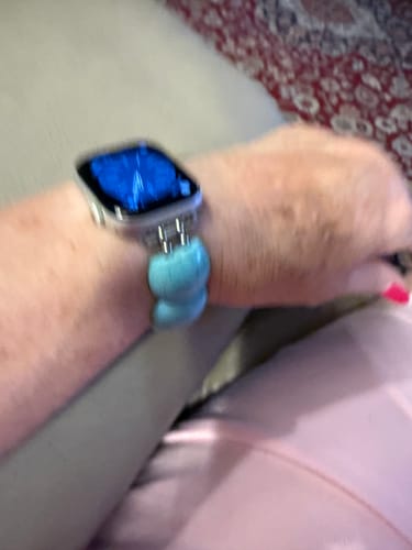Customer's hand wearing the turquoise Arizona Western Stretch Apple Watch Strap.