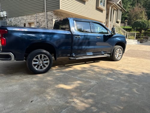 Customer's blue Chevy Silverado 1500 parked on a driveway after installing the 3-inch front and 2-inch rear lift kit.