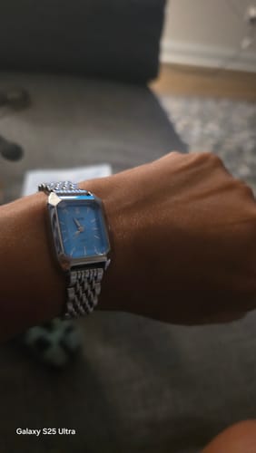 Customer's silver Claire De Mains watch with a blue face worn on a person's wrist.