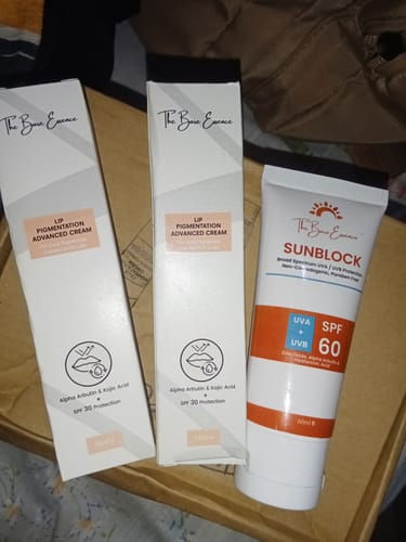 Customer's pack of two white Advanced Lip Pigmentation Cream boxes and one white Sunblock tube with orange labeling