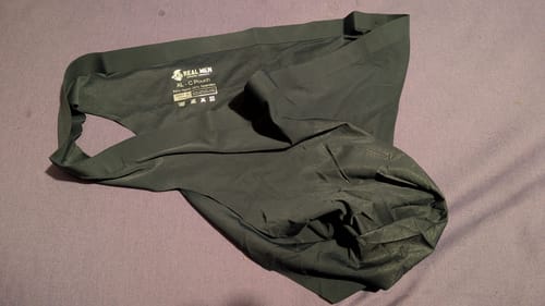 Customer's black Real Men seamless thong, showing the interior label and construction.
