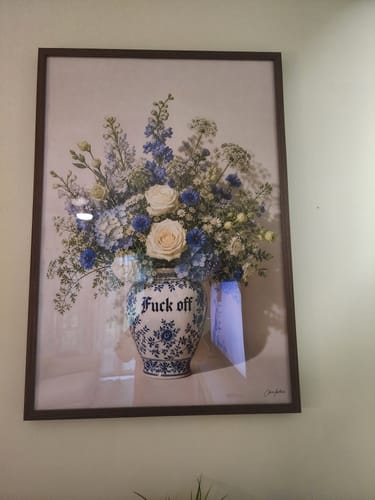 Customer's Dark Oak Gallery Frame hanging on a wall, displaying a floral print in a blue and white vase.