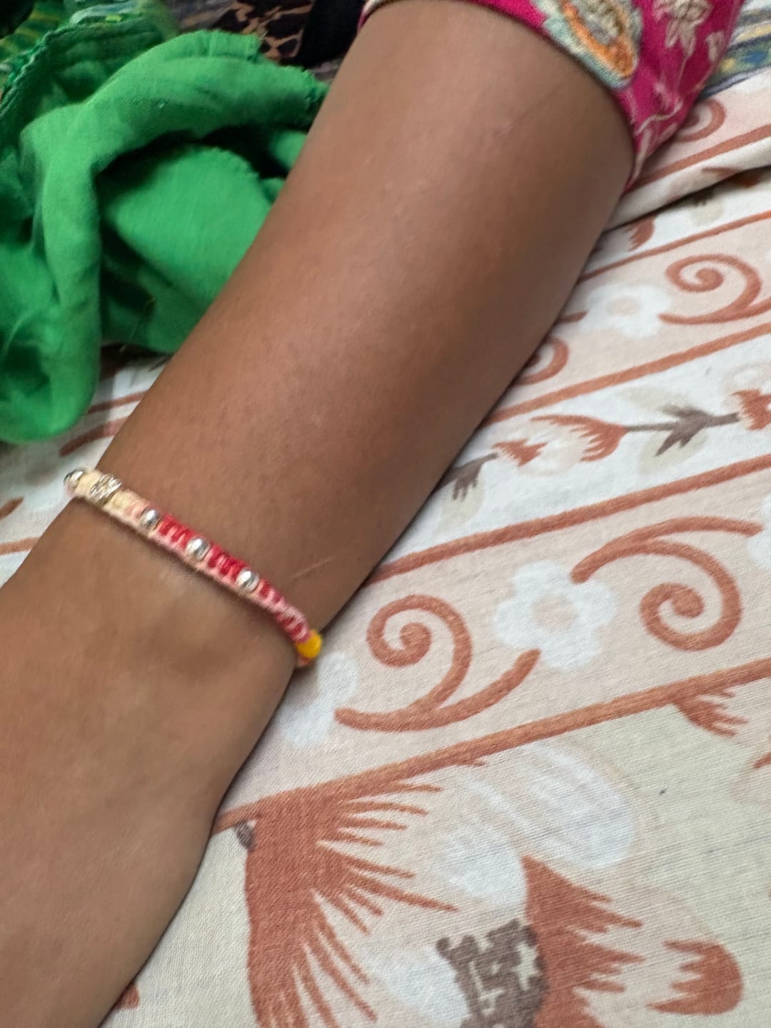 Customer photo review of Divine Om Silver Rakhi Thread