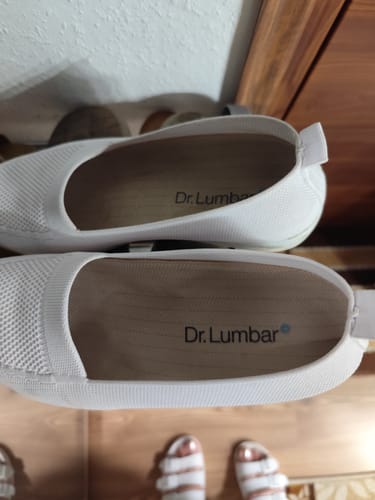 Customer's pair of white Ortopéd Pro orthopedic shoes with Dr. Lumbar branding visible on the inside soles.