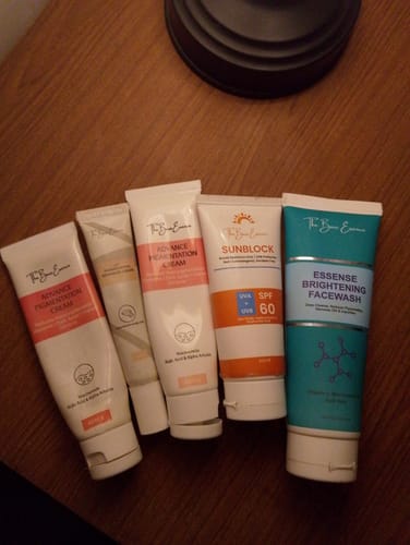 Customer's collection of Eco Pigmentation Bundle skincare tubes and a sunblock bottle on a wooden surface.