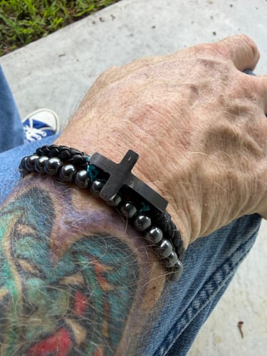 Customer's FIDES Cross Leather & Magnetic Titanium Bead Bracelet worn on a tattooed wrist.