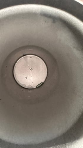 Customer's To-Go Buddy interior showing a clean, metallic base with a few small droplets of water.