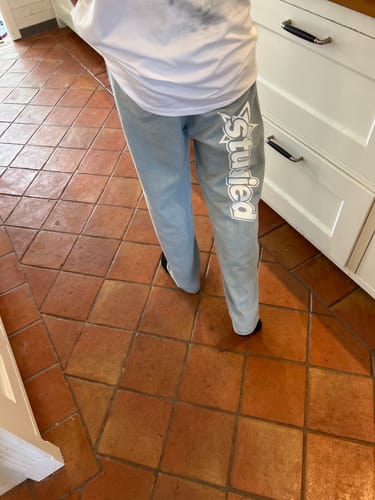 Customer's light blue Jean Studied baggy jeans with large vertical white logo, worn with a white shirt