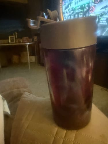 Customer's Northern Lights Universal XL stainless steel cup with lid and straw sitting indoors.