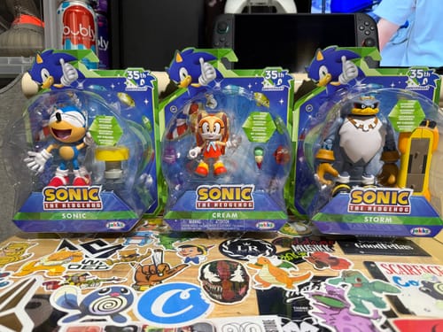 Customer's Sonic the Hedgehog 35th Anniversary action figure in packaging, alongside Cream and Storm figures.
