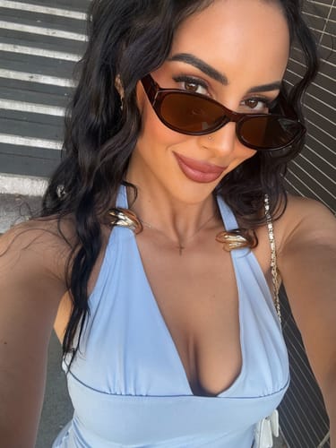 Reviewer wearing Infinaluxe Lash Extensions, looking at camera while outdoors
